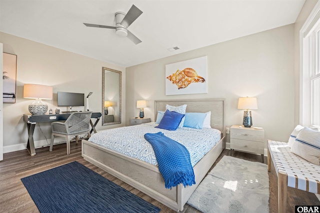 bedroom featuring visible vents, ceiling fan, baseboards, and wood finished floors