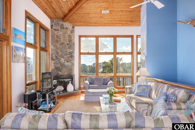 living room with wood finished floors, high vaulted ceiling, beam ceiling, a fireplace, and wood ceiling