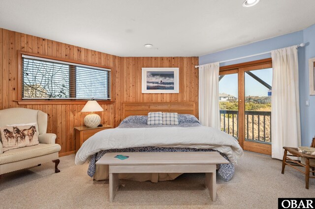 bedroom featuring access to exterior, multiple windows, and carpet floors