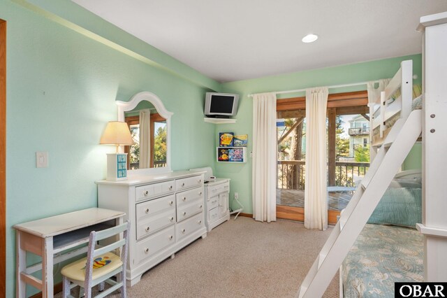 bedroom with baseboards and light carpet