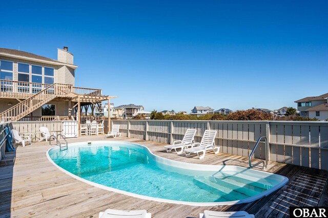 view of swimming pool featuring a fenced in pool and a deck