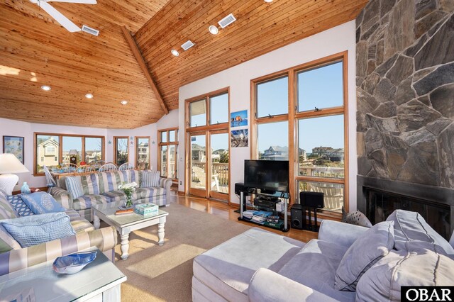 living area with high vaulted ceiling, wood finished floors, recessed lighting, a fireplace, and wood ceiling