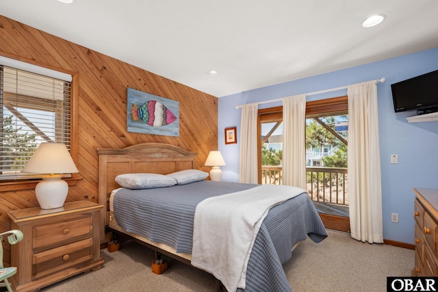 bedroom featuring access to outside, recessed lighting, wood walls, carpet flooring, and baseboards