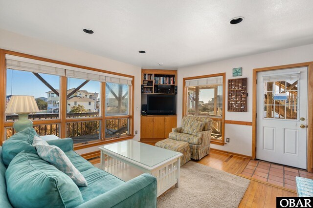 living room with recessed lighting and light wood-style floors