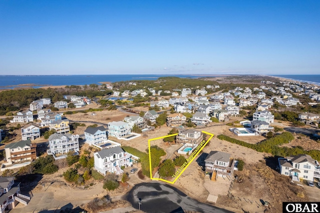 birds eye view of property with a residential view and a water view