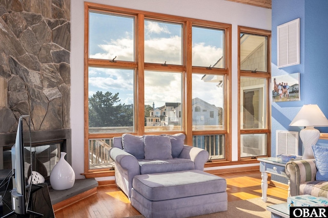 living room with visible vents and wood finished floors