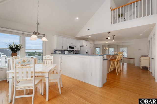 716 Moongate Ln Lot 51, Corolla, NC 27927 - dining space featuring light wood-style floors, a chandelier, high vaulted ceiling, and recessed lighting