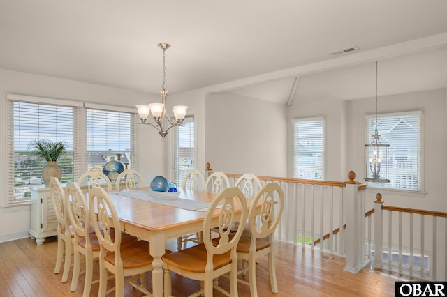 716 Moongate Ln Lot 51, Corolla, NC 27927 - dining space featuring a chandelier, light wood-style floors, baseboards, and lofted ceiling