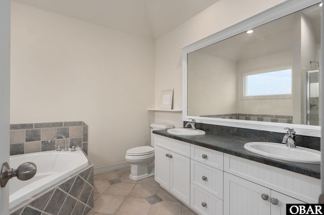 716 Moongate Ln Lot 51, Corolla, NC 27927 - bathroom with double vanity, a garden tub, baseboards, tile patterned floors, and toilet