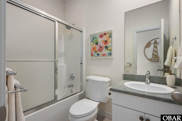 716 Moongate Ln Lot 51, Corolla, NC 27927 - full bathroom with toilet, vanity, combined bath / shower with glass door, and a textured wall