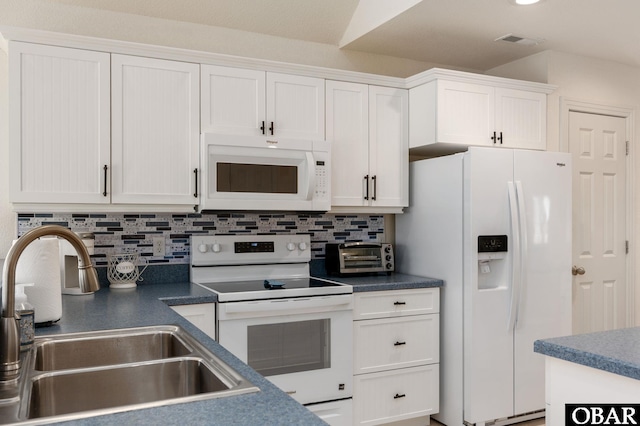 716 Moongate Ln Lot 51, Corolla, NC 27927 - kitchen featuring white appliances, a sink, white cabinets, and tasteful backsplash