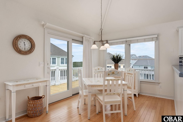 716 Moongate Ln Lot 51, Corolla, NC 27927 - dining room featuring light wood-style floors, baseboards, and a chandelier