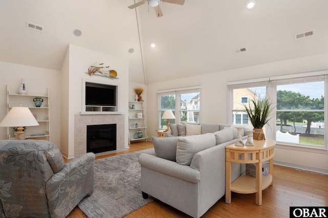 716 Moongate Ln Lot 51, Corolla, NC 27927 - living area with light wood-type flooring, ceiling fan, high vaulted ceiling, a fireplace, and recessed lighting