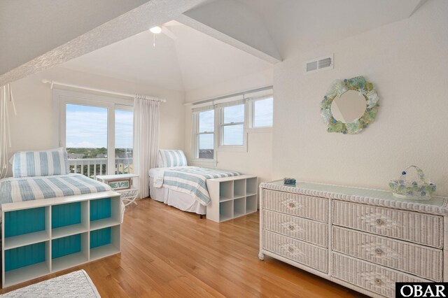 716 Moongate Ln Lot 51, Corolla, NC 27927 - bedroom with lofted ceiling and wood finished floors