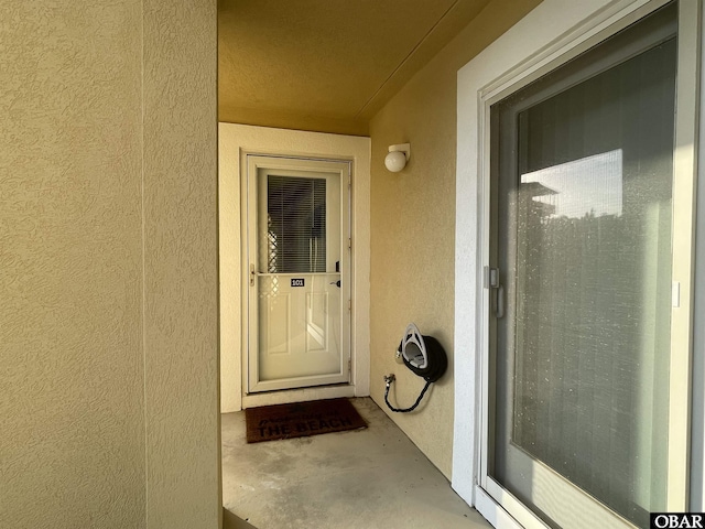entrance to property featuring stucco siding