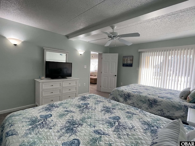 bedroom with baseboards, carpet, a ceiling fan, and a textured ceiling