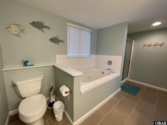 bathroom with a jetted tub, a stall shower, tile patterned floors, baseboards, and toilet