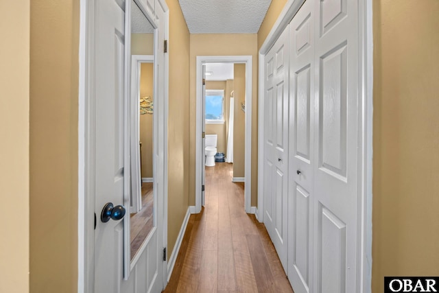 612 Pirates Way Unit # 612B, Manteo, NC 27954 - corridor with dark wood finished floors, baseboards, and a textured ceiling