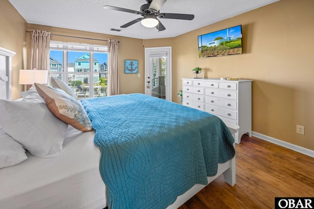 612 Pirates Way Unit # 612B, Manteo, NC 27954 - bedroom with access to outside, wood finished floors, baseboards, a textured ceiling, and a ceiling fan