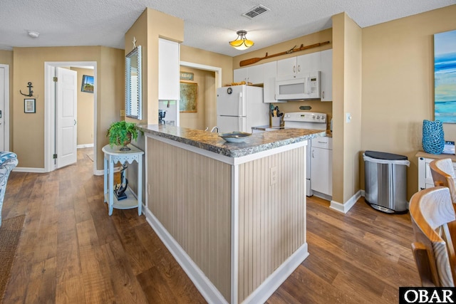 612 Pirates Way Unit # 612B, Manteo, NC 27954 - kitchen with white appliances, dark wood-type flooring, baseboards, white cabinetry, and a textured ceiling