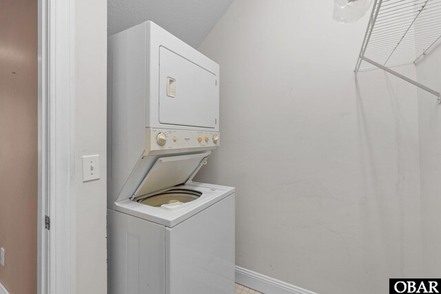 50336 Great Ridge Rd, Frisco, NC 27936 - washroom featuring baseboards and stacked washer / drying machine