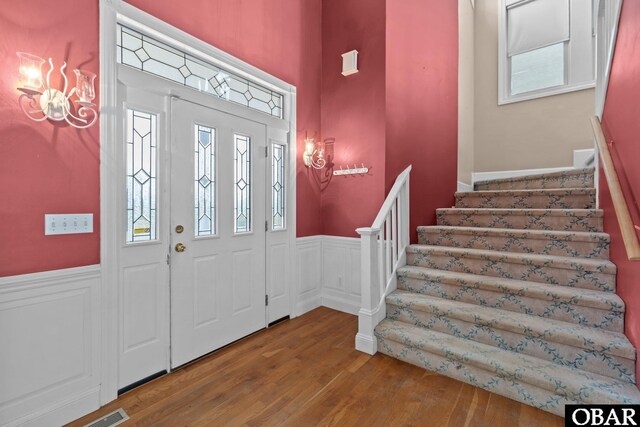 50336 Great Ridge Rd, Frisco, NC 27936 - foyer entrance featuring stairs, wainscoting, and wood finished floors