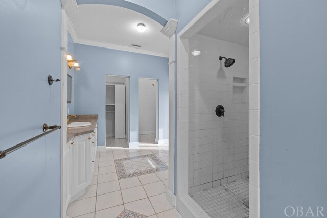50336 Great Ridge Rd, Frisco, NC 27936 - bathroom with visible vents, tiled shower, tile patterned floors, crown molding, and vanity