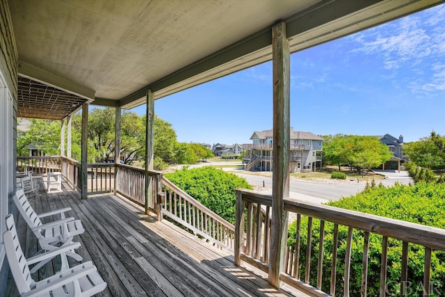 wooden deck featuring a porch and a residential view