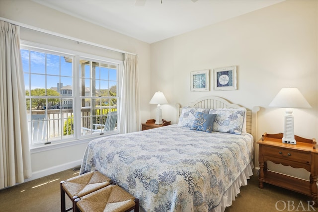 bedroom featuring dark colored carpet and baseboards