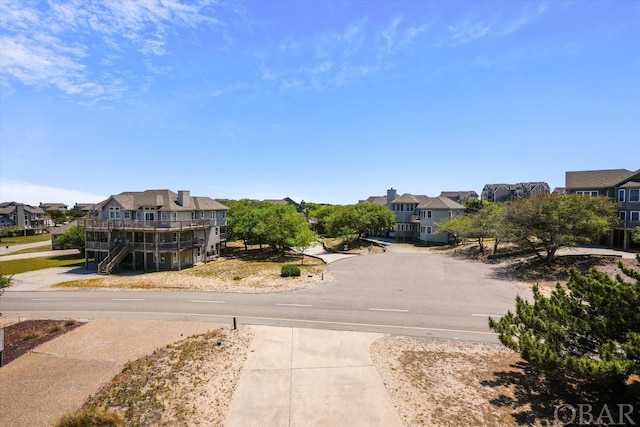 view of street with stairs, sidewalks, and a residential view