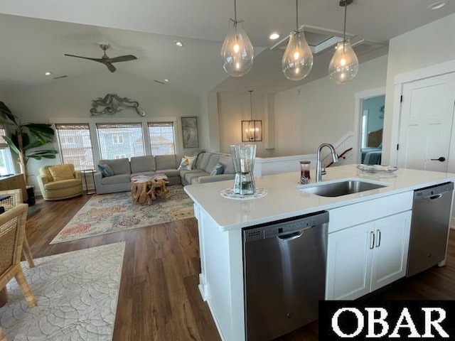 kitchen featuring open floor plan, dishwasher, and a sink