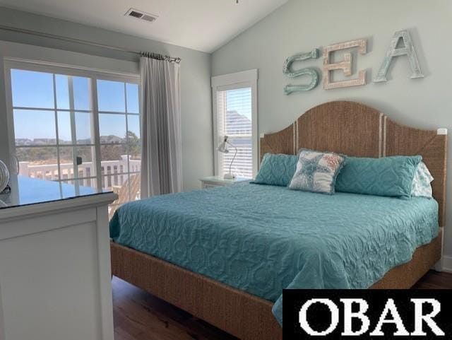 bedroom featuring visible vents, vaulted ceiling, and wood finished floors