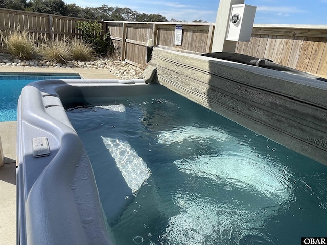 view of swimming pool featuring fence and a fenced in pool