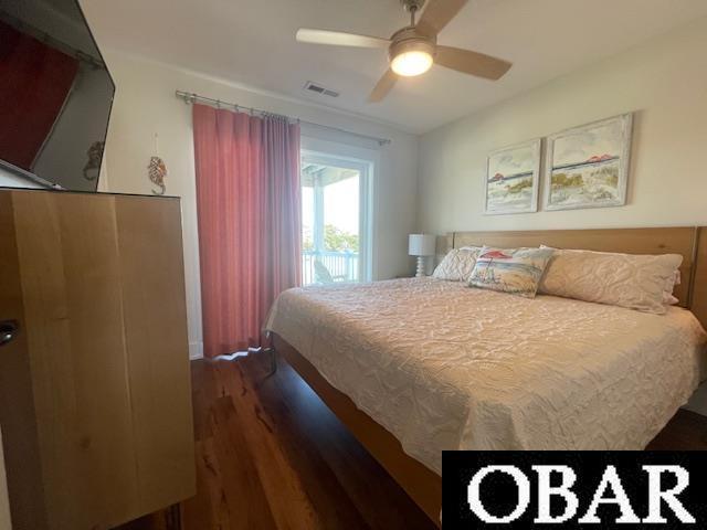 bedroom with a ceiling fan, visible vents, and wood finished floors