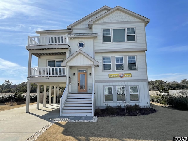 986 N Harbor Vw Lot # 2R, Corolla, NC 27927 - view of front of property featuring a carport, a balcony, driveway, and board and batten siding