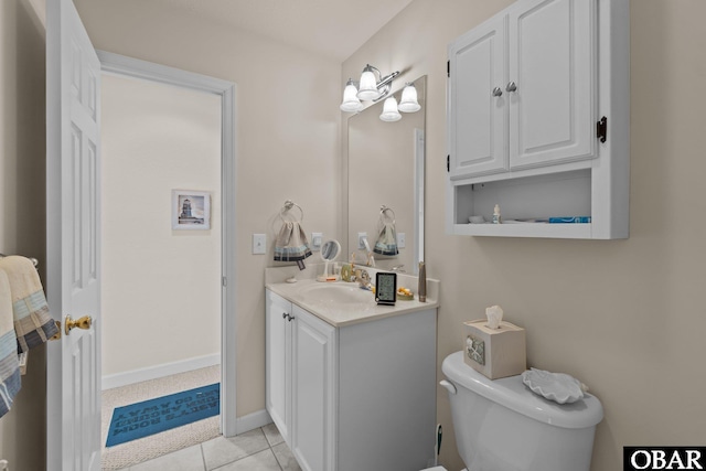 bathroom featuring baseboards, vanity, toilet, and tile patterned floors