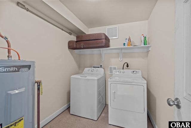 laundry room with washing machine and clothes dryer, visible vents, electric water heater, laundry area, and baseboards