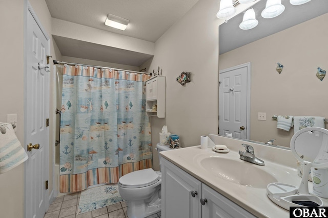 bathroom with vanity, toilet, and tile patterned floors