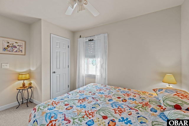 bedroom with ceiling fan, baseboards, and carpet flooring