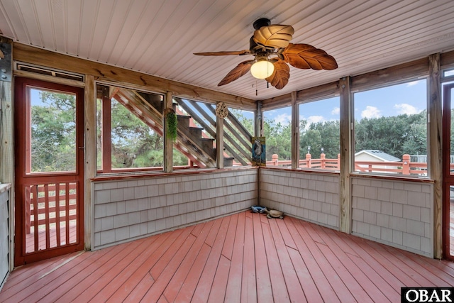 unfurnished sunroom with a ceiling fan