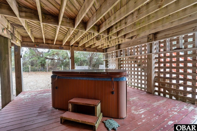 wooden deck with a hot tub