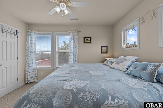 bedroom featuring ceiling fan, visible vents, and carpet flooring