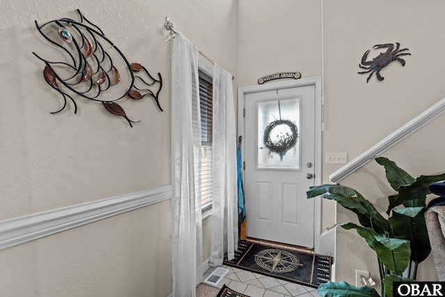 entryway with tile patterned flooring and visible vents