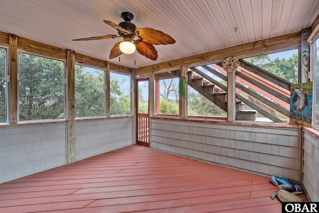 unfurnished sunroom with ceiling fan and wood ceiling