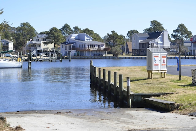 dock area featuring a water view and a residential view