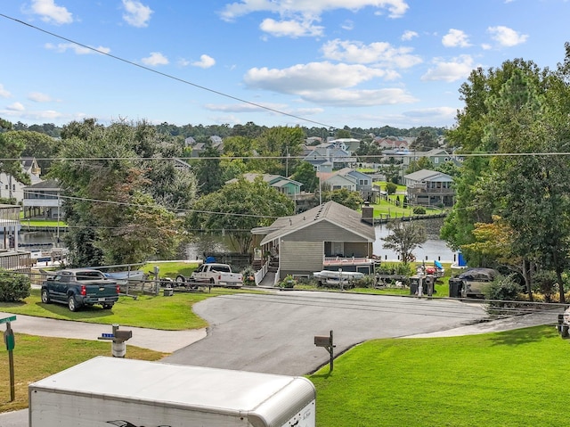 view of street with a residential view and a water view