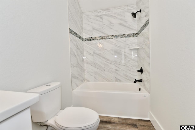 full bath featuring toilet, baseboards, wood finished floors, and shower / bathtub combination