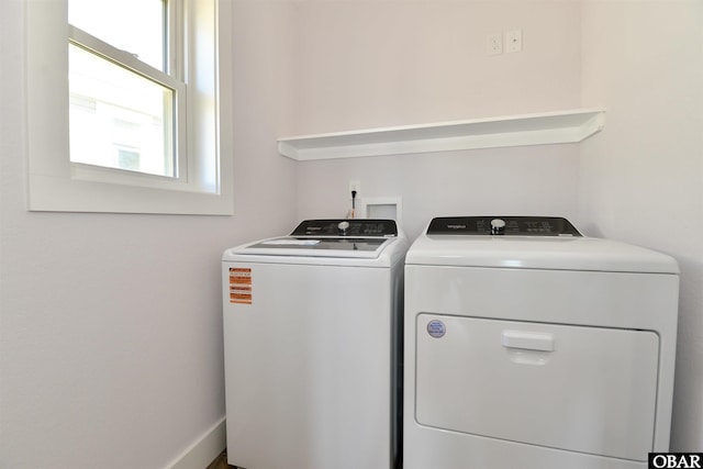 laundry area featuring laundry area, washer and clothes dryer, and baseboards