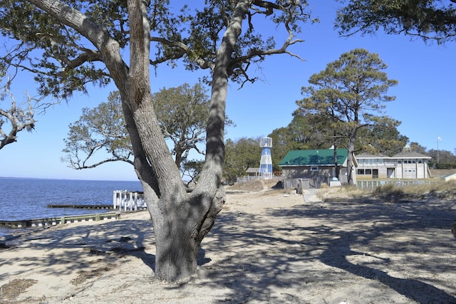 view of yard with a dock and a water view