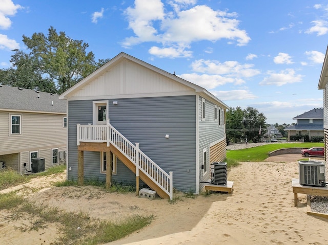 rear view of property featuring central AC